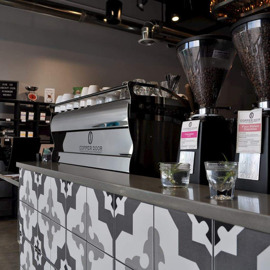 Copper Door Coffee Roasters with espresso machine and grinders