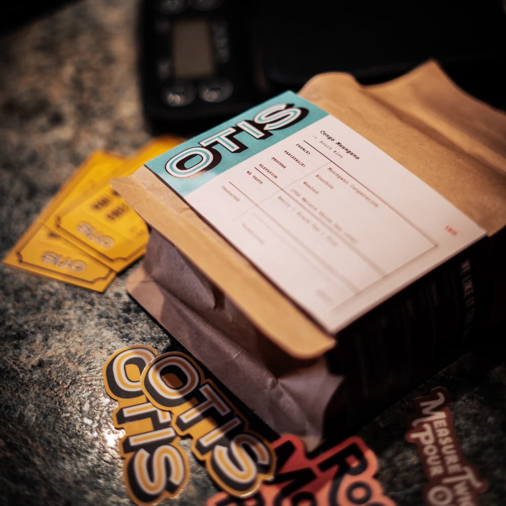 Bag of specialty coffee from Otis along with stickers and free drink cards as part of Native Coffee Club