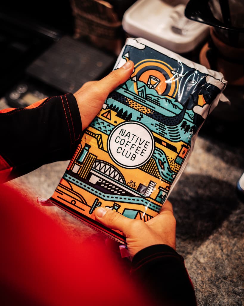 Person holding shipping bag from Native Coffee Club